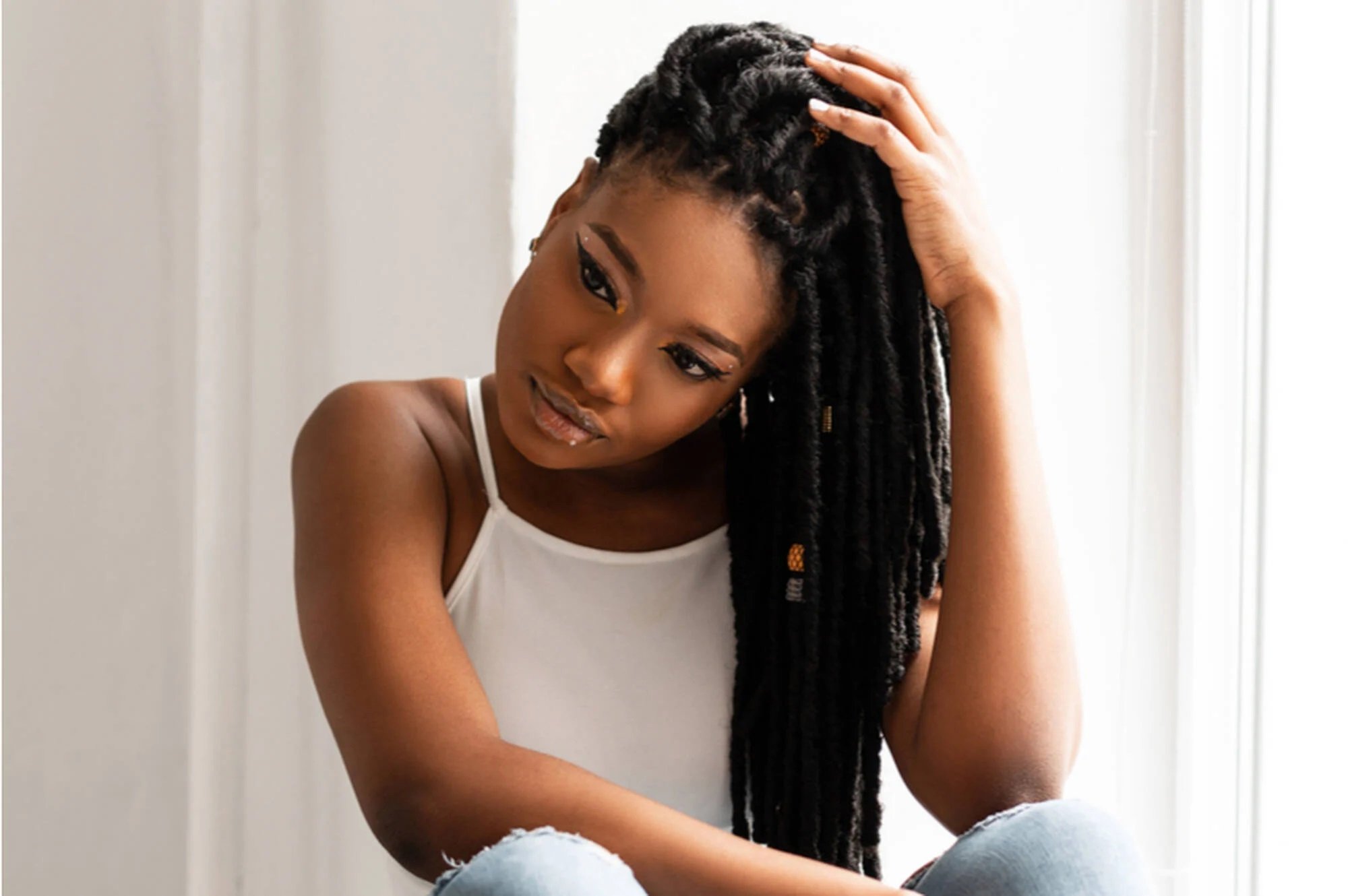 How to Retwist Your Locs At Home, According to Natural Hair Experts